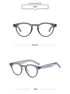 Detail view of grey translucent round sunglasses with silver star decor on temples
