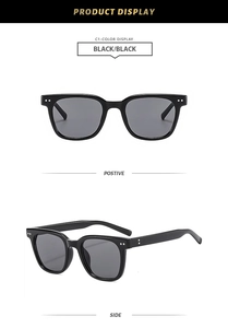 Detail view of square black sunglasses with silver rivet accents and glossy finish