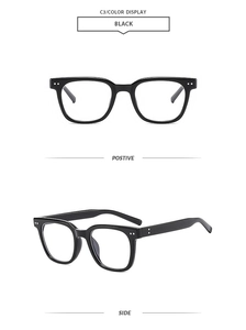 Detail of black square frame sunglasses with metal rivet accents and glossy finish