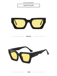 Detail view of bold polygon sunglasses in black frame with yellow lenses for retro style