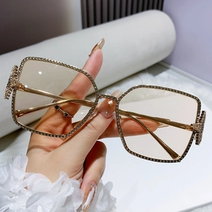 Golden square frame sunglasses with rhinestone embellishments and light brown lenses
