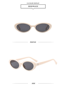 Detail view of oval beige sunglasses with metallic dots and dark polarized lenses