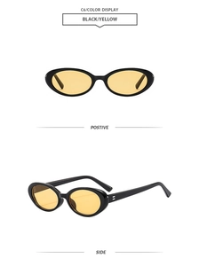 Detail view of oval sunglasses with glossy black frames and yellow tinted lenses