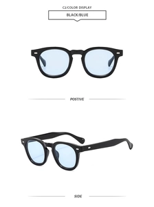 Detail of vintage black frames with blue translucent lenses and silver rivets