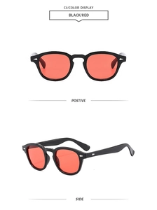 Detail view of retro round sunglasses in black and red with silver metal rivets