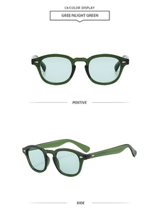 Detail view of vintage round sunglasses with translucent green frame and arrow rivets