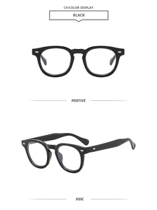 Detail view of classic black oval frame sunglasses with vintage rivets and side temples
