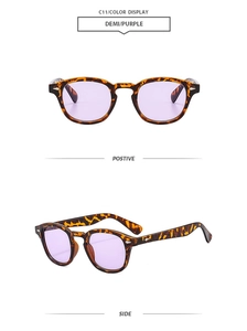 Close-up of vintage round demi frame sunglasses with purple lenses and stud details