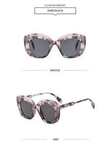 Détails de lunettes de soleil oversize avec gravure trèfle sur monture demi foncée