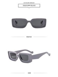 Detail view of square gray sunglasses with thick stepped frames and black lenses