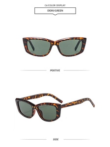 Detail view of tortoiseshell square sunglasses with dark green lenses and spotted frame