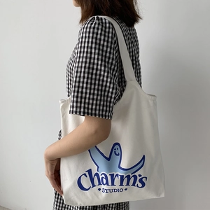 Japanese style white canvas tote bag with blue cartoon graphic and wide shoulder strap