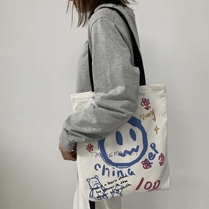 Large capacity white canvas tote bag with blue graffiti smiley face for daily use