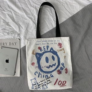 Detailed macro shot of an off-white canvas tote bag with artistic colorful graffiti patterns