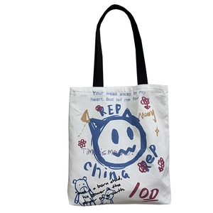 Large white canvas tote bag with black handles and vintage graffiti patterns for women