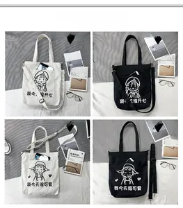 Detail of canvas tote bag showing black and white colors with cartoon graphics and pockets