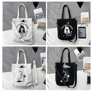 Detail view of canvas tote bags in black and white with cute girl character prints