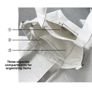 Detail of canvas tote bag interior with three compartments and zipper divider for storage