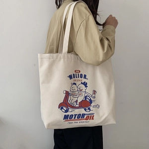 Retro cartoon canvas tote bag in beige with large capacity shown on model shoulder