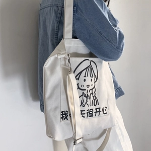 Detail of white canvas tote bag with adjustable strap and cute cartoon girl illustration
