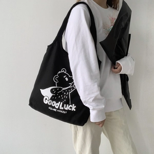 Japanese style black canvas tote bag featuring a cute cartoon bear and GoodLuck print