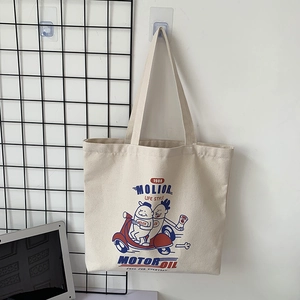 Detail of off-white canvas tote bag featuring vintage American cartoon motorcycle print