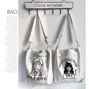 Detail view of canvas tote bag with girl illustration and adjustable shoulder strap