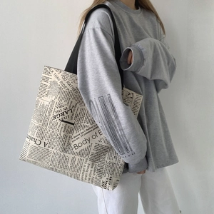 Retro newspaper print canvas tote bag with black shoulder strap for daily travel use