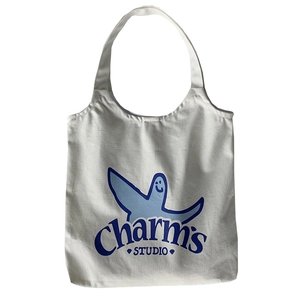 Japanese style white canvas tote bag with blue cartoon graphic and shoulder strap