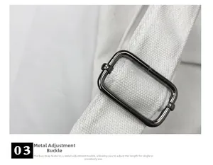 Close-up of durable dark metal adjustment buckle on white canvas shoulder strap