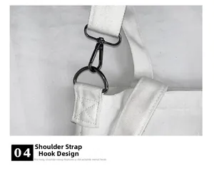 Detail of detachable gun-metal hook and D-ring on white canvas crossbody shoulder bag