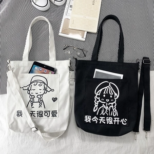 Detail view of canvas tote bags with adjustable straps and cute cartoon girl illustrations