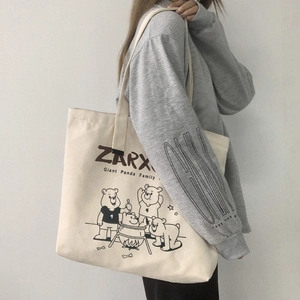Detail of canvas tote bag featuring cute cartoon bear print and large storage capacity