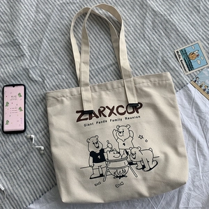 Close-up of cream canvas tote bag featuring cute cartoon bear family reunion illustration