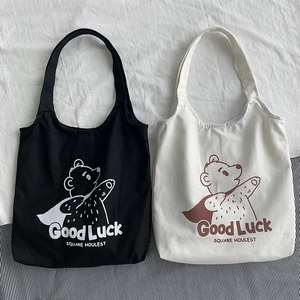 Japanese style canvas tote bags with cartoon bear print and Good Luck slogan in two colors