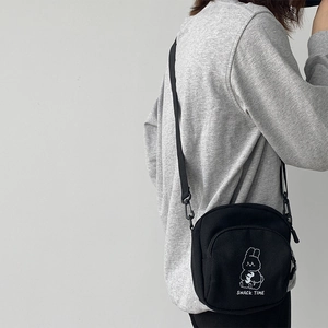 Cute black canvas crossbody bag featuring white cartoon rabbit print and snack time text
