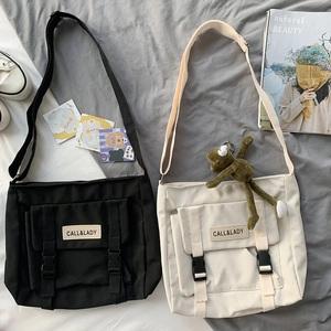 Detailed flat lay of nylon messenger bags in black and beige with adjustable straps
