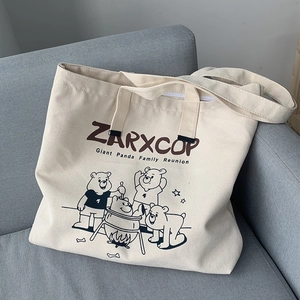 Detail of canvas tote bag with ZARXCOP panda family print and sturdy zipper closure