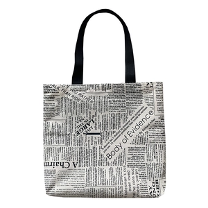 Large vintage newspaper print canvas shoulder bag with black straps on white background
