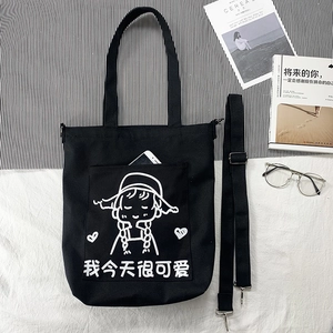 Detail of black canvas tote bag with cute girl illustration and adjustable shoulder strap