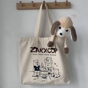 Detail of canvas tote bag featuring cute cartoon bear prints and ZARXCUP branding logo