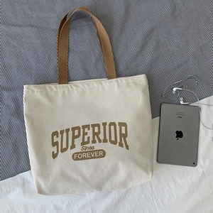 Retro canvas tote bag with brown straps and large Superior typography for daily use