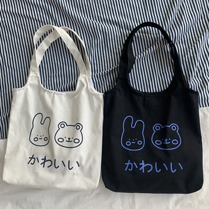 Detail view of Japanese canvas tote bags with cute bunny and bear graphic prints