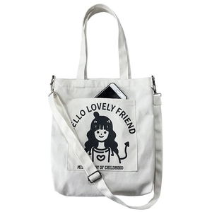 White canvas crossbody tote bag with cartoon girl print and front smartphone pocket
