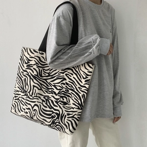 Détail du sac fourre-tout en toile à rayures zébrées avec des anses renforcées