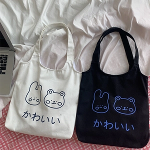 Detail of cute Japanese style canvas tote bags with bear and rabbit cartoon prints