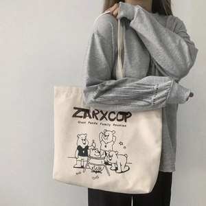 Off-white large canvas tote bag with ZARXCOP cartoon panda print on shoulder model
