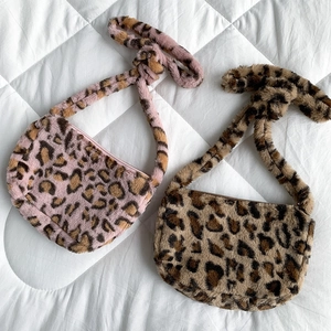 Detailed top view of soft leopard print plush crossbody bags in pink and brown tones