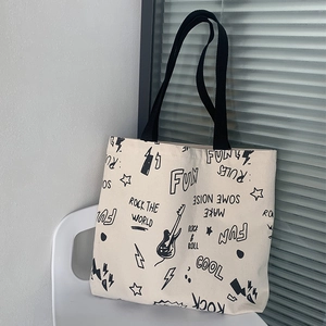 Détail du sac cabas en toile graffiti rock avec motif guitare et bandoulières noires