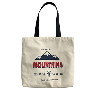 Off-white canvas tote bag with mountain print and black handles for daily casual use